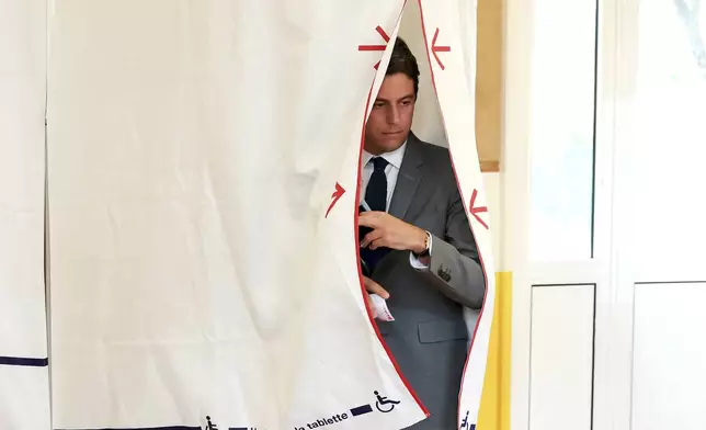 French Prime Minister Gabriel Attal, leaves the polling booth before voting for the second round of the legislative election, Sunday, July 7, 2024 in Vanves, outside Paris. Voting has begun in mainland France on Sunday in pivotal runoff elections that could hand a historic victory to Marine Le Pen's far-right National Rally and its inward-looking, anti-immigrant vision — or produce a hung parliament and years of political deadlock. (Alain Jocard, Pool via AP)