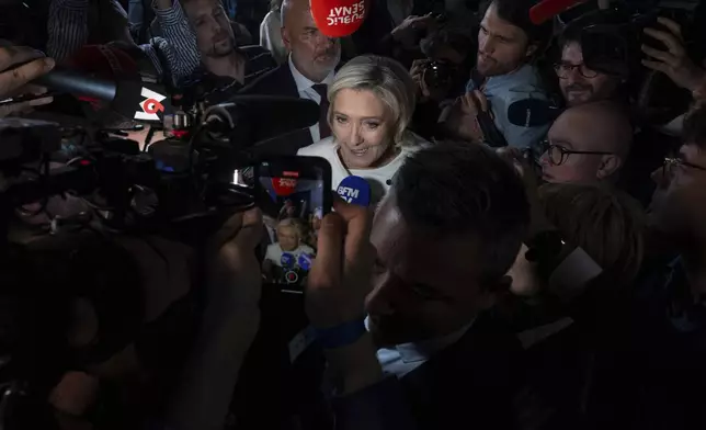 Far-right National Rally party leader Marine Le Pen answers reporters after the second round of the legislative election, Sunday, July 7, 2024, at the party election night headquarters in Paris. A coalition on the left that came together unexpectedly ahead of France's snap elections won the most parliamentary seats in the vote, according to polling projections Sunday. The surprise projections put President Emmanuel Macron's centrist alliance in second and the far right in third. (AP Photo/Louise Delmotte)