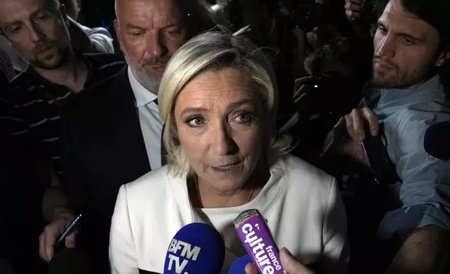 Far-right National Rally party leader Marine Le Pen answers reporters after the second round of the legislative election, Sunday, July 7, 2024 at the party election night headquarters in Paris. A coalition on the left that came together unexpectedly ahead of France's snap elections won the most parliamentary seats in the vote, according to polling projections Sunday. The surprise projections put President Emmanuel Macron's centrist alliance in second and the far right in third. (AP Photo/Louise Delmotte)