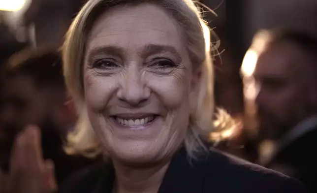 French far right leader Marine Le Pen smiles after delivering her speech after the release of projections based on the actual vote count in select constituencies , Sunday, June 30, 2024 in Henin-Beaumont, northern France. French voters propelled the far-right National Rally to a strong lead in first-round legislative elections Sunday and plunged the country into political uncertainty, according to polling projections. (AP Photo/Thibault Camus)