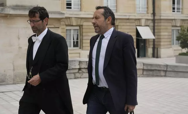 Elected parliament member Sebastien Chenu, right, of the far-right National Rally party, arrives at the National Assembly, Monday, July 1, 2024 in Paris. France's National Rally surged into the lead in the first round of legislative elections, according to results released early Monday, bringing the far-right party to the brink of power and dealing a major blow to President Emmanuel Macron's centrists in an election that could set the country, and Europe, on a starkly different course. (AP Photo/Thibault Camus)