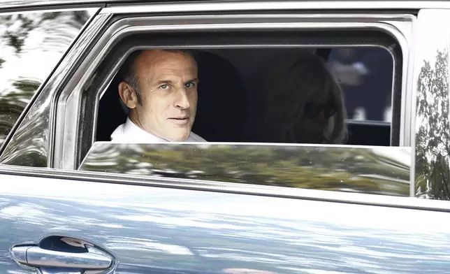 French President Emmanuel Macron and his wife Brigitte Macron leave after voting for the second round of the legislative elections in Le Touquet-Paris-Plage, northern France, Sunday July 7 2024. Voting has begun in mainland France on Sunday in pivotal runoff elections that could hand a historic victory to Marine Le Pen's far-right National Rally and its inward-looking, anti-immigrant vision — or produce a hung parliament and political deadlock. (Mohammed Badra, Pool via AP)