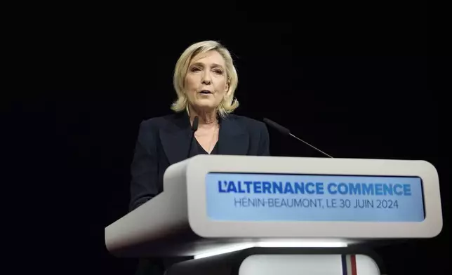 French far right leader Marine Le Pen delivers her speech after the release of projections based on the actual vote count in select constituencies , Sunday, June 30, 2024 in Henin-Beaumont, northern France. French voters propelled the far-right National Rally to a strong lead in first-round legislative elections Sunday and plunged the country into political uncertainty, according to polling projections. (AP Photo/Thibault Camus)
