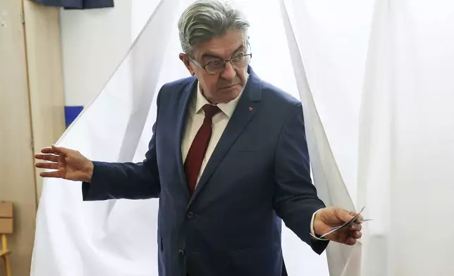 Far left leader Jean-Luc Melenchon exits the voting booth before voting, in Paris, Sunday, June 30, 2024. (AP Photo/Thomas Padilla)