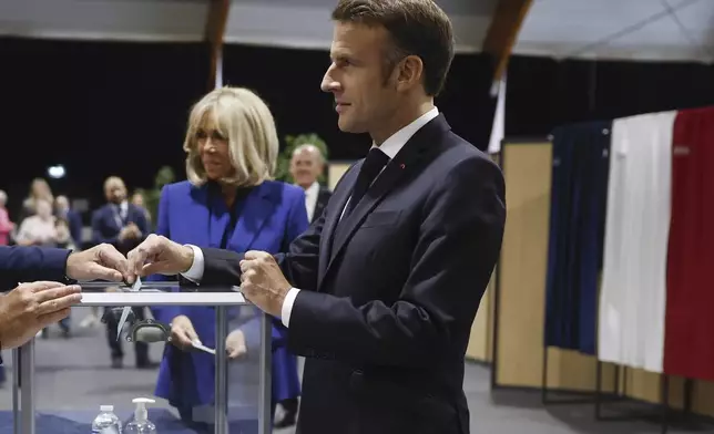 French President Emmanuel Macron votes for the second round of the legislative elections in Le Touquet-Paris-Plage, northern France, Sunday July 7 2024. Voting has begun in mainland France on Sunday in pivotal runoff elections that could hand a historic victory to Marine Le Pen's far-right National Rally and its inward-looking, anti-immigrant vision — or produce a hung parliament and political deadlock. (Mohammed Badra, Pool via AP)