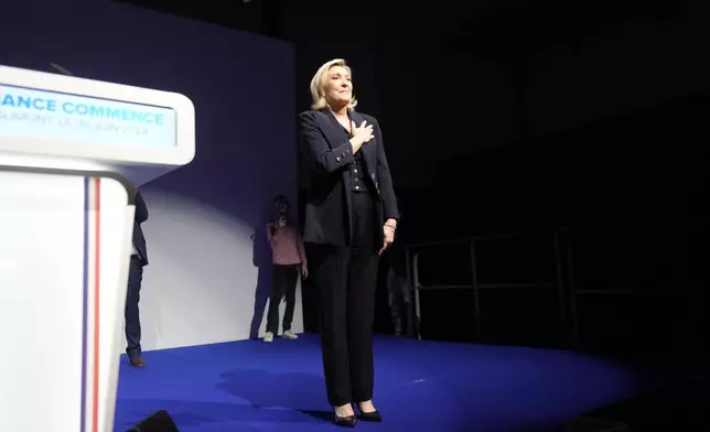 French far right leader Marine Le Pen gestures after delivering her speech after the release of projections based on the actual vote count in select constituencies in Henin-Beaumont, northern France, Sunday, June 30, 2024. (AP Photo/Thibault Camus)