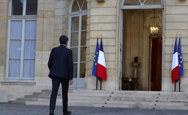 French Prime Minister Gabriel Attal walks back to the Prime Minister residence after delivering a speech following the second round of the legislative elections, Sunday, July 7, 2024 in Paris. A coalition of the French left that quickly banded together to beat a surging far right in legislative elections won the most seats in parliament but not a majority, according to polling projections Sunday, a stunning outcome that threatens to plunge the country into political and economic turmoil. (AP Photo/Aurelien Morissard)