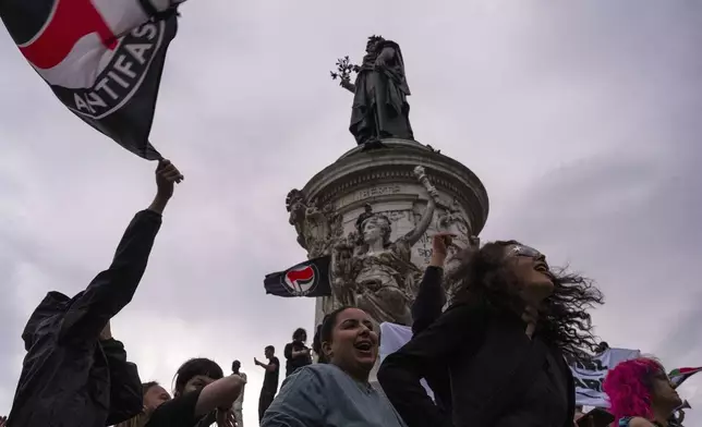 People gather at Republique plaza to protest the far-right National Rally, which came out strongly ahead in first-round legislative elections in Paris, Sunday, June 30, 2024. (AP Photo/Louise Delmotte)