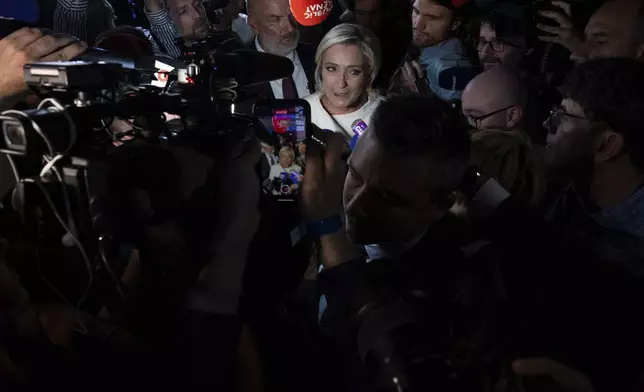 Far-right National Rally party leader Marine Le Pen answers reporters after the second round of the legislative election, Sunday, July 7, 2024, at the party election night headquarters in Paris. A coalition on the left that came together unexpectedly ahead of France's snap elections won the most parliamentary seats in the vote, according to polling projections Sunday. The surprise projections put President Emmanuel Macron's centrist alliance in second and the far right in third. (AP Photo/Louise Delmotte)