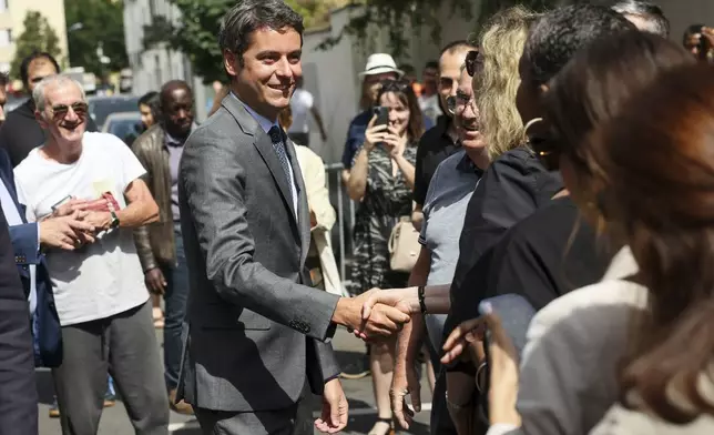 French Prime Minister Gabriel Attal arrives to vote for the first round of parliamentary elections in Vanves, outside Paris, Sunday, June 30, 2024. (AP Photo/Thomas Padilla)