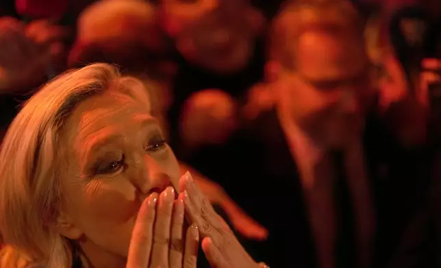French far right leader Marine Le Pen blows a kiss after delivering her speech after the release of projections based on the actual vote count in select constituencies in Henin-Beaumont, northern France, Sunday, June 30, 2024. (AP Photo/Thibault Camus)
