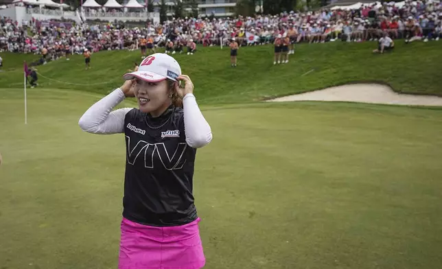 Ayaka Furue, of Japan, celebrates after winning the Evian Championship women's golf tournament, in Evian, eastern France, Sunday, July 14, 2024. (AP Photo/Laurent Cipriani)