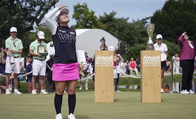 Ayaka Furue, of Japan, looks at the sky as she celebrates after winning the Evian Championship women's golf tournament, in Evian, eastern France, Sunday, July 14, 2024. (AP Photo/Laurent Cipriani)