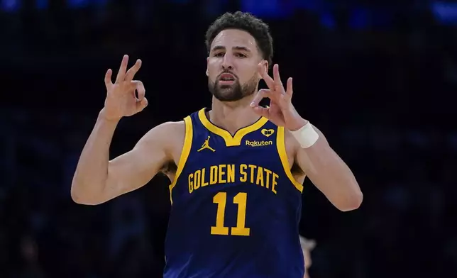 FILE - Golden State Warriors guard Klay Thompson gestures after making a 3-point basket against the Los Angeles Lakers during the second half of an NBA basketball game Tuesday, April 9, 2024, in Los Angeles. Klay Thompson is moving on from the Golden State Warriors, with the four-time league champion agreeing to join the Western Conference champion Dallas Mavericks and change franchises for the first time in his 13-year NBA career, two people with knowledge of the decision said Monday, July 1, 2024.(AP Photo/Ryan Sun)