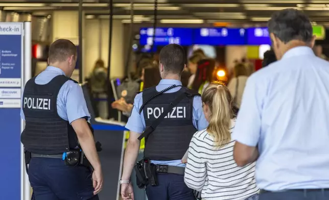 Police patrol the terminal at Frankfurt Airport in Frankfurt, Germany, Thursday, July 25 ,2024. (Helmut Fricke/dpa via AP)