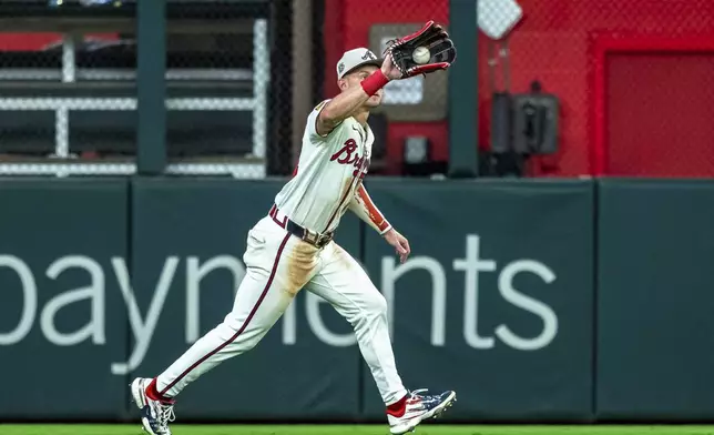Atlanta Braves outfielder Jarred Kelenic catches a pop fly during the ninth inning of a baseball game against the San Fransisco Giants, Thursday, July 4, 2024, in Atlanta. (AP Photo/Jason Allen)