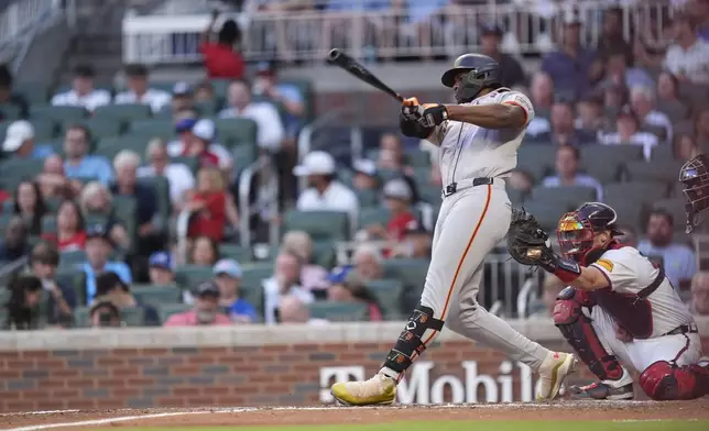 San Francisco Giants' Jorge Soler (2) hits a solo home run in the fifth inning of a baseball game against the Atlanta Braves, Tuesday, July 2, 2024, in Atlanta. (AP Photo/Brynn Anderson)