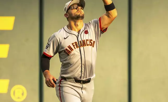 San Fransisco left fielder Forrest Wall catches a pop fly during the first inning of a baseball game against the Atlanta Braves, Thursday, July 4, 2024, in Atlanta. (AP Photo/Jason Allen)
