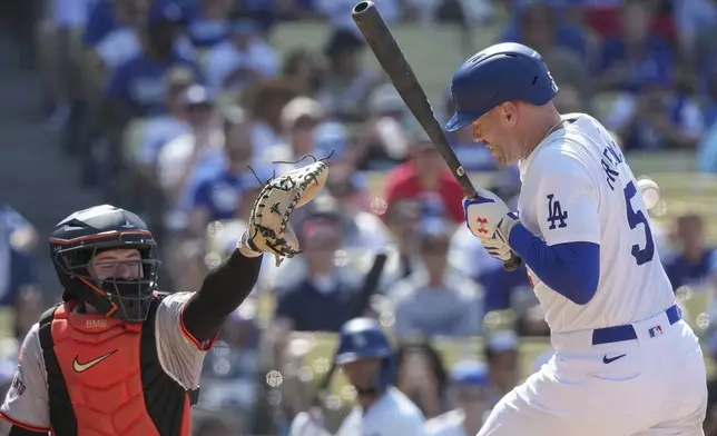 Los Angeles Dodgers' Freddie Freeman (5) is hit by a pitch during the eighth inning of a baseball game against the San Francisco Giants in Los Angeles, Thursday, July 25, 2024. (AP Photo/Eric Thayer)