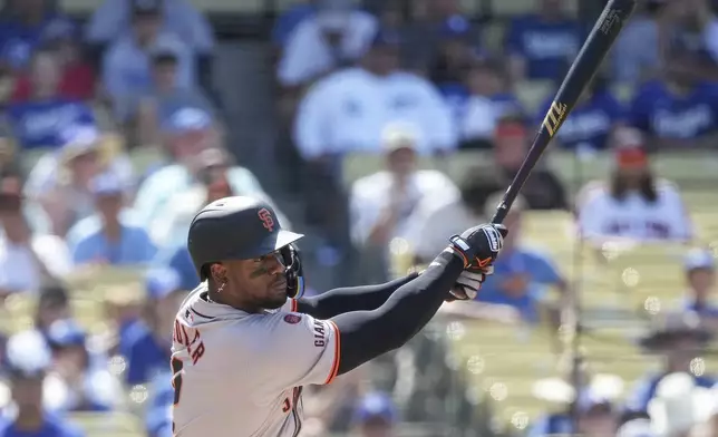 San Francisco Giants designated hitter Jorge Soler hits a single during the eighth inning of a baseball game against the Los Angeles Dodgers in Los Angeles, Thursday, July 25, 2024. (AP Photo/Eric Thayer)