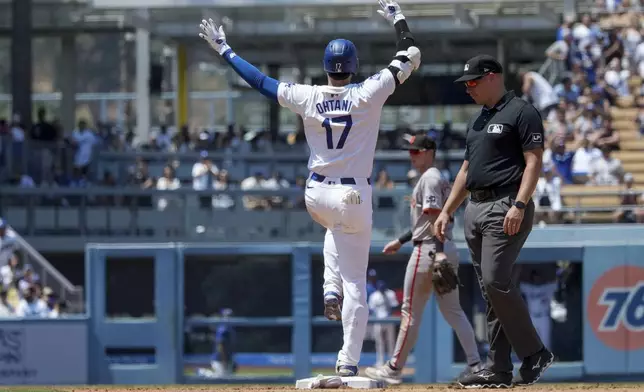 Los Angeles Dodgers designated hitter Shohei Ohtani (17) celebrates after hitting a single during the fourth inning of a baseball game against the San Francisco Giants in Los Angeles, Thursday, July 25, 2024. (AP Photo/Eric Thayer)