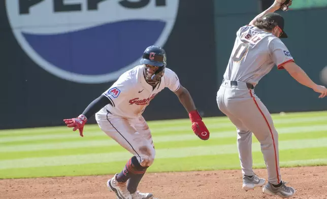 San Francisco Giants' Brett Wisely (0) forces out Cleveland Guardians' Angel Martinez, left, at second base during the second inning of a baseball game in Cleveland, Saturday, July 6, 2024. (AP Photo/Phil Long)