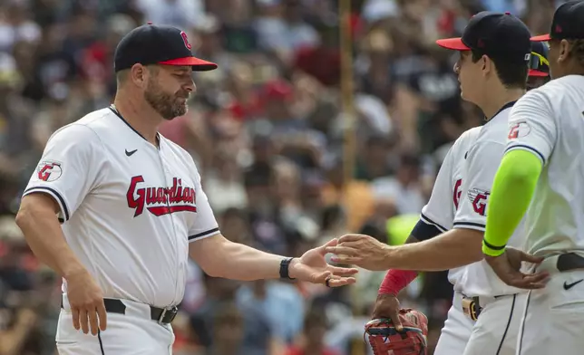 Cleveland Guardians manager Stephen Vogt, left, takes the ball from starter Logan Allen during the fifth inning of a baseball game against the San Francisco Giants in Cleveland, Saturday, July 6, 2024. (AP Photo/Phil Long)