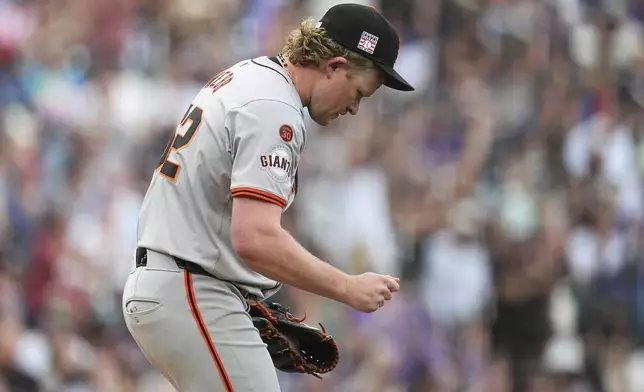 San Francisco Giants starting pitcher Logan Webb reacts after giving up a two-run home run to Colorado Rockies' Ezequiel Tovar in the fifth inning of a baseball game Saturday, July 20, 2024, in Denver. (AP Photo/David Zalubowski)