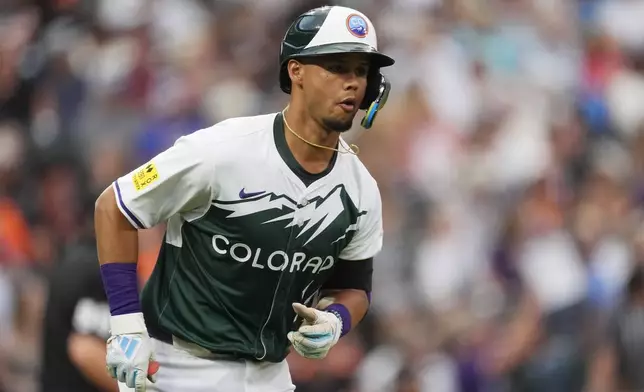 Colorado Rockies' Ezequiel Tovar heads up the first-base line after hitting a two-run home run off San Francisco Giants starting pitcher Logan Webb in the fifth inning of a baseball game Saturday, July 20, 2024, in Denver. (AP Photo/David Zalubowski)