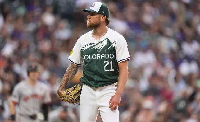 Colorado Rockies starting pitcher Kyle Freeland stares at home plate umpire Chris Conroy while disagreeing with a call in the fifth inning of a baseball game against the San Francisco Giants Saturday, July 20, 2024, in Denver. (AP Photo/David Zalubowski)