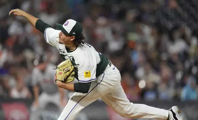 Colorado Rockies relief pitcher Victor Vodnik works against the San Francisco Giants in the ninth inning of a baseball game Saturday, July 20, 2024, in Denver. (AP Photo/David Zalubowski)