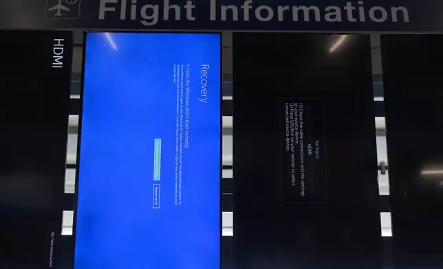 A "blue screen of death" is displayed instead of flight information at Chicago O'Hare International Airport after a software glitch caused widespread outages as reported by airlines around the world, Friday, July 19, 2024, in Chicago. (AP Photo/Erin Hooley)