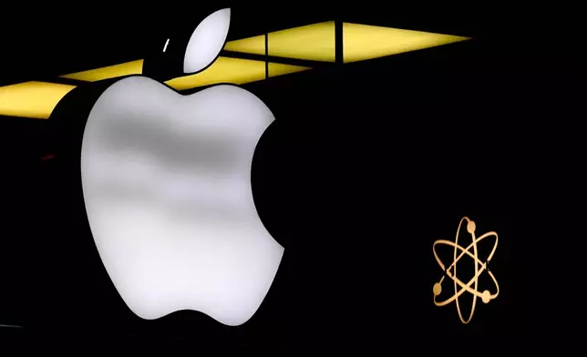 FILE - The Apple logo is illuminated at a store in Munich, Germany, Nov. 13, 2023. The dependence — and extreme vulnerability — starts with the interconnections that bind our computers, phones and other devices. (AP Photo/Matthias Schrader, File)