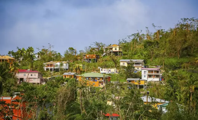 Roofs of houses lie damaged by Hurricane Beryl in St. Patrick, Grenada, Tuesday, July 2, 2024. (AP Photo/Haron Forteau)