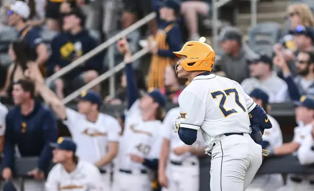 FILE - West Virginia's J.J. Wetherholt watches his home run against Baylor during a college baseball game, April 26, 2024, in Morgantown, W.Va. The Cleveland Guardians have the No. 1 overall pick in next week's draft. They have narrowed the talent pool to just a few possibilities with Oregon State second baseman Travis Bazzana, Georgia outfielder/third baseman Charlie Condon and West Virginia middle infielder Wetherholt believed to be the frontrunning options. (William Wotring/The Dominion-Post via AP, File)