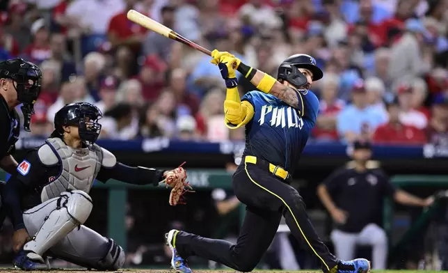 Philadelphia Phillies' Bryson Stott, right, watches his solo home run off Cleveland Guardians' Ben Lively during the fifth inning of a baseball game, Friday, July 26, 2024, in Philadelphia. (AP Photo/Derik Hamilton)