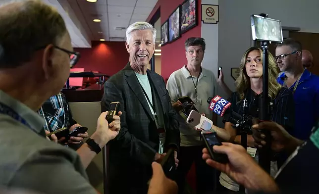 Philadelphia Phillies president of baseball operations David Dombrowski, center left, speaks with members of the media prior to a baseball game against the Cleveland Guardians, Friday, July 26, 2024, in Philadelphia. (AP Photo/Derik Hamilton)