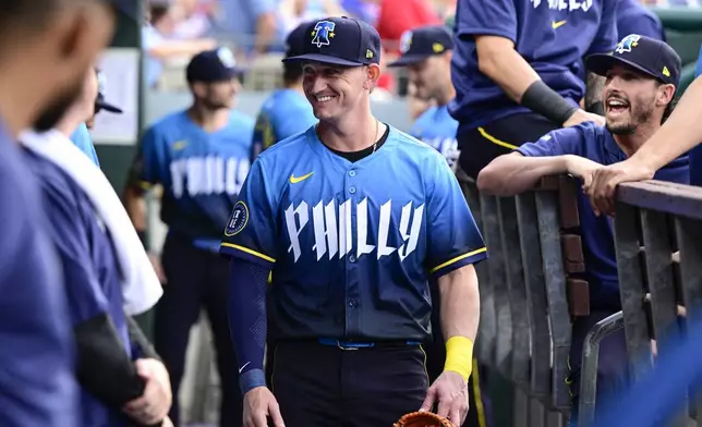 Philadelphia Phillies' Austin Hays is greeted by teammates in the dugout prior to a baseball game against the Cleveland Guardians, Friday, July 26, 2024, in Philadelphia. (AP Photo/Derik Hamilton)