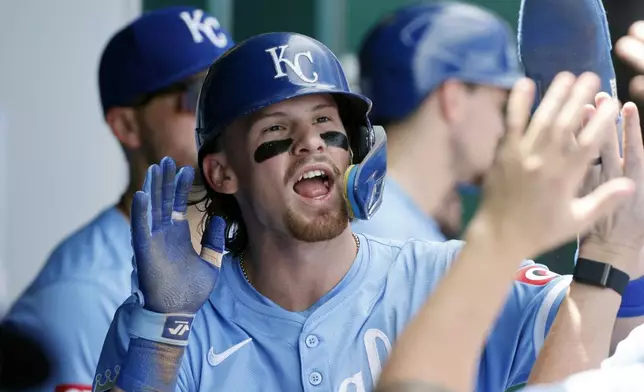 Kansas City Royals' Bobby Witt Jr. celebrates in the dugout after scoring from third off a Hunter Renfroe single during the fifth inning of a baseball game against the Cleveland Guardians in Kansas City, Mo., Sunday, June 30, 2024. (AP Photo/Colin E. Braley)