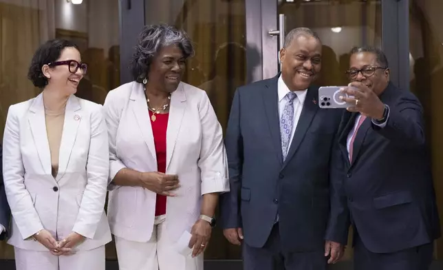 U.S. Assistant Secretary for Western Hemisphere Affairs Brian Nichols, right, holds out a cell phone to take a photo with, from right, Haitian Prime Minister Garry Conille, U.S. Ambassador to the United Nations Linda Thomas-Greenfield and Haitian Foreign Minister Dominque Dupuy before they meet with the Haitian Transitional Presidential Council at the Villa d'Accueil in Port-au-Prince, Haiti, Monday, July 22, 2024. (Roberto Schmidt/Pool via AP)