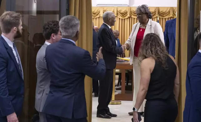 U.S. Ambassador to the United Nations Linda Thomas-Greenfield, top right, shakes hands with Edgard Leblanc Fils, head of the Haitian Transitional Presidential Council, after a meeting at the Villa d'Accueil in Port-au-Prince, Haiti, Monday, July 22, 2024. (Roberto Schmidt/Pool via AP)