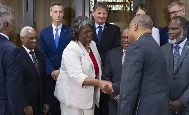 U.S. Ambassador to the United Nations Linda Thomas-Greenfield, center, shakes hands with Haitian Prime Minister Garry Conille as they gather for a group photo with the Transitional Presidential Council after a meeting at the Villa d'Accueil in Port-au-Prince, Haiti, Monday, July 22, 2024. (Roberto Schmidt/Pool via AP)