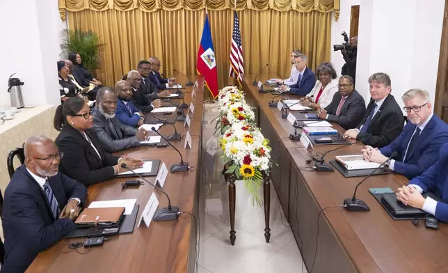 U.S. Ambassador to the United Nations Linda Thomas-Greenfield, fourth from right, poses for photos after meeting with members of Haiti's Transitional Presidential Council, left side of table, at the Villa d'Accueil in Port-au-Prince, Haiti, Monday, July 22, 2024. (Roberto Schmidt/Pool via AP)