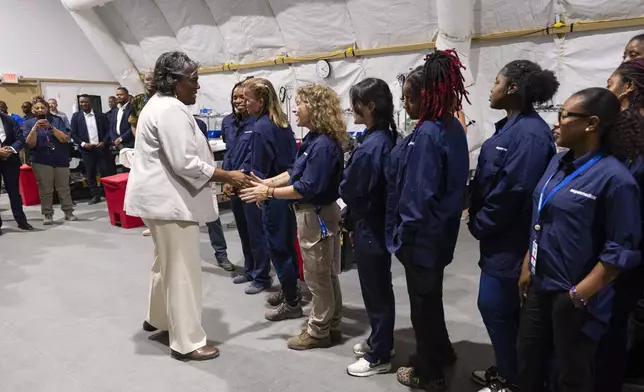 U.S. Ambassador to the United Nations Linda Thomas-Greenfield, left, greets doctors and nurses part of a U.N.-backed, multinational security mission at their base in Port-au-Prince, Haiti, Monday, July 22, 2024. (Roberto Schmidt/Pool Photo via AP)