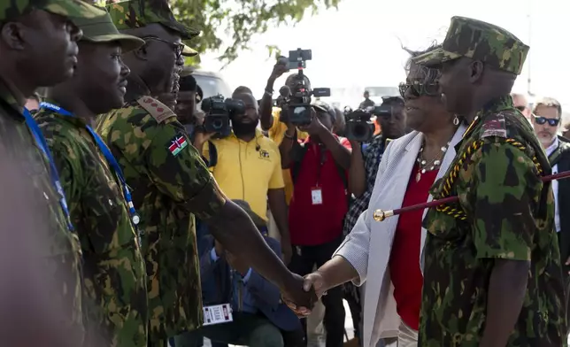 U.S. Ambassador to the United Nations Linda Thomas-Greenfield, second from right, shakes hands with a Kenyan police officer part of a UN-backed multinational force during a visit to their base near the airport in Port-au-Prince, Haiti, Monday, July 22, 2024. (Roberto Schmidt/Pool Photo via AP)