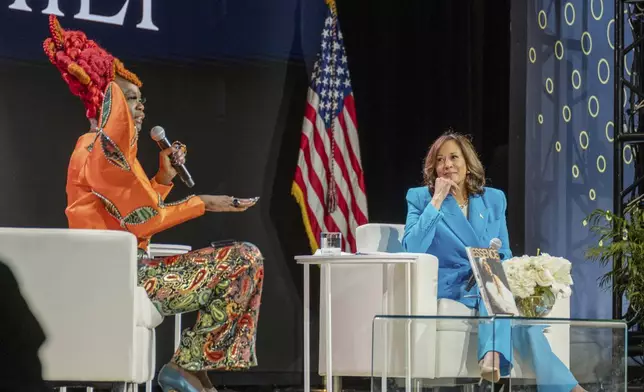 Vice President Kamala Harris, right, listens as Essence CEO Caroline Wanga speaks during the 30th annual Essence Festival of Culture in New Orleans, Saturday, July 6, 2024. (Matthew Perschall/The Times-Picayune/The New Orleans Advocate via AP)