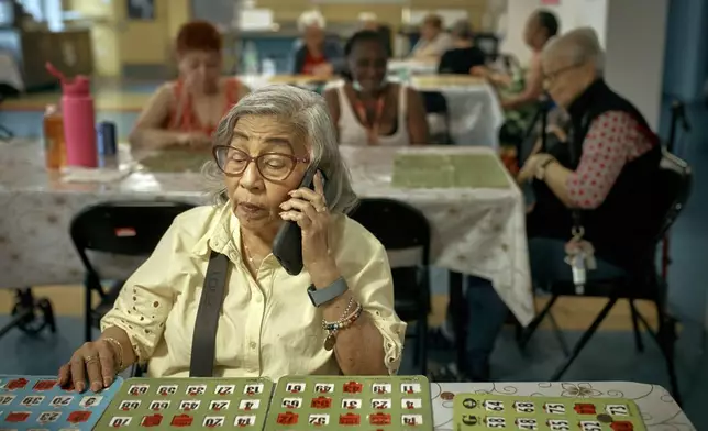 Elderly women play bingo at a cooling center during a hot day, Friday, June 21, 2024, in the Bronx Borough of New York. The heat isn’t just uncomfortable. It’s the top cause of weather-related fatalities nationwide, quietly killing an average of 350 New Yorkers each year, according to a city mortality report.(AP Photo/Andres Kudacki)