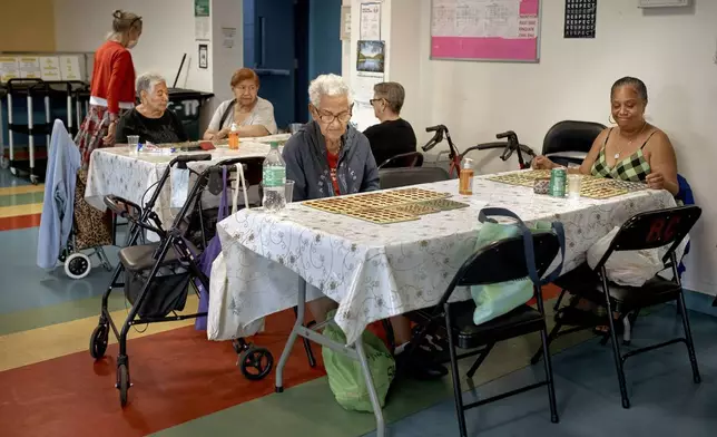 Elderly women play bingo at a cooling center during a hot day, Friday, June 21, 2024, in the Bronx Borough of New York. The heat isn’t just uncomfortable. It’s the top cause of weather-related fatalities nationwide, quietly killing an average of 350 New Yorkers each year, according to a city mortality report. (AP Photo/Andres Kudacki)