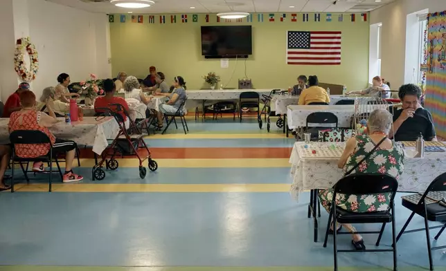 Elderly women play bingo at a cooling center during a hot day, Friday, June 21, 2024, in the Bronx Borough of New York. The heat isn’t just uncomfortable. It’s the top cause of weather-related fatalities nationwide, quietly killing an average of 350 New Yorkers each year, according to a city mortality report.(AP Photo/Andres Kudacki)