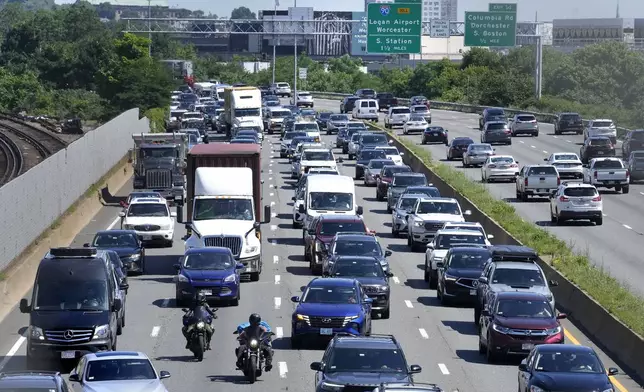 Vehicles move slowly in south-bound lanes, left, of Interstate Route 93, in Boston, Wednesday, July 3, 2024, as people make their way out of the city. Boston roadways saw traffic delays Wednesday in many areas the day before the July Fourth Independence Day holiday. (AP Photo/Steven Senne)